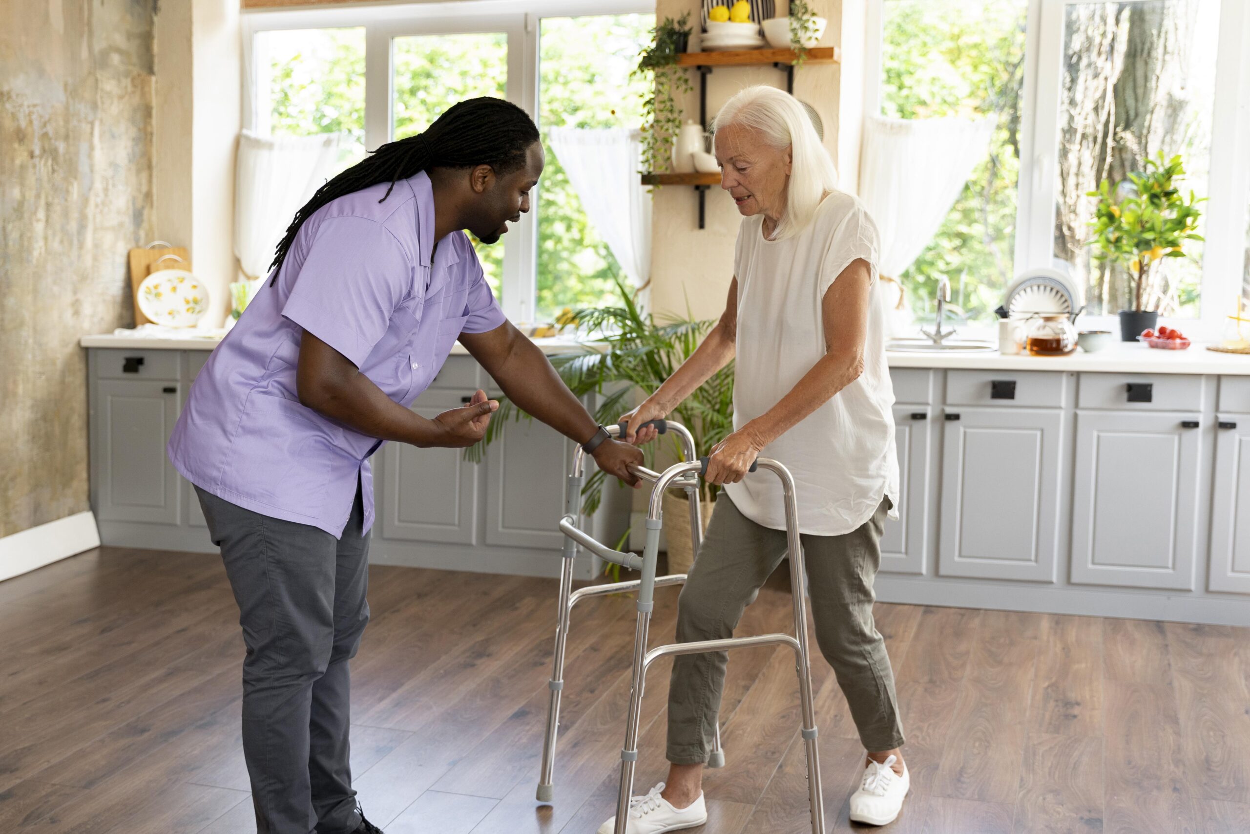 male social worker taking care old woman scaled.jpg